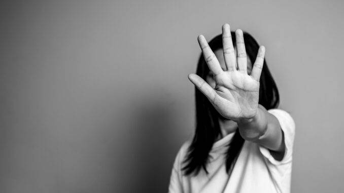 woman raised her hand for dissuade, campaign stop violence against women. Asian woman raised her hand for dissuade with copy space, black and white color